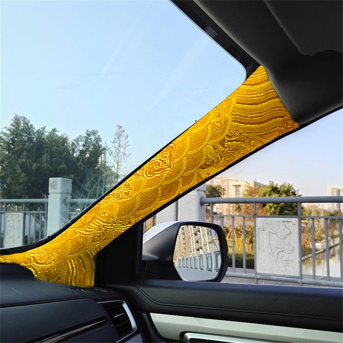 Gold embroidered wrap fitted to a car A-pillar