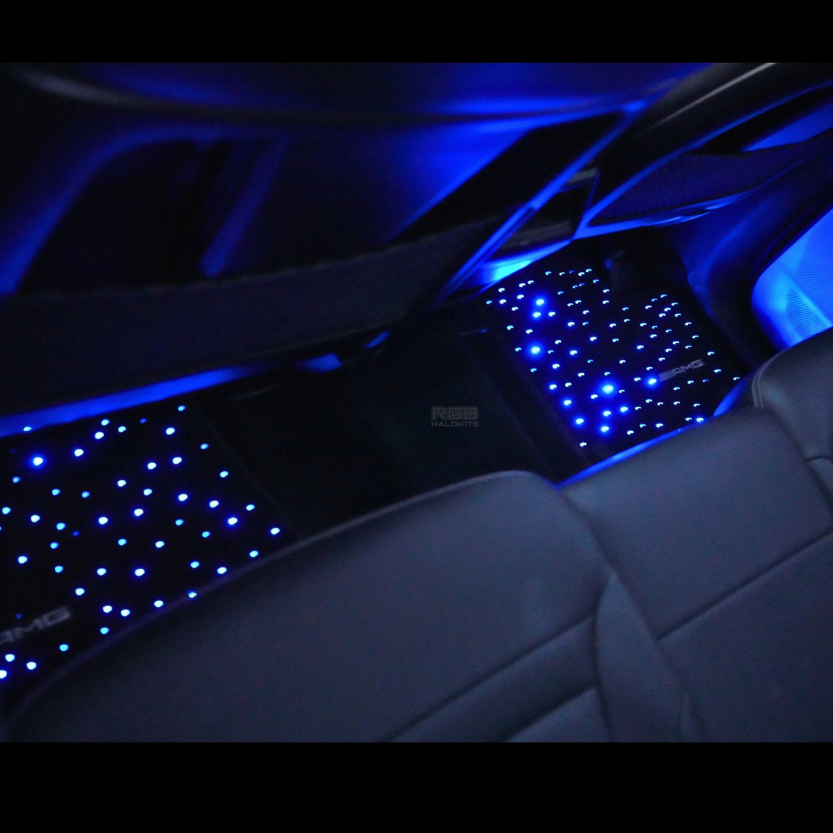 Starlight floor mats glowing blue in a car