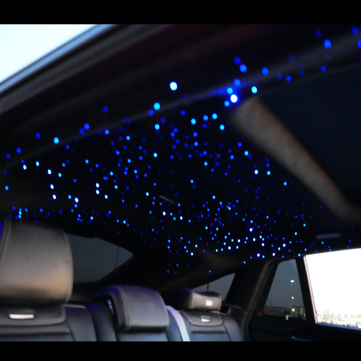 Starlight headliner lit blue inside a car